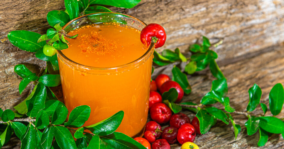 Fresh fruits and acerola juice (Malpighia emarginata). Acerola is a fruit rich in vitamin C, used in juices and ice cream. Tropical fruit. Energy drink. Natural and antioxidant drink.