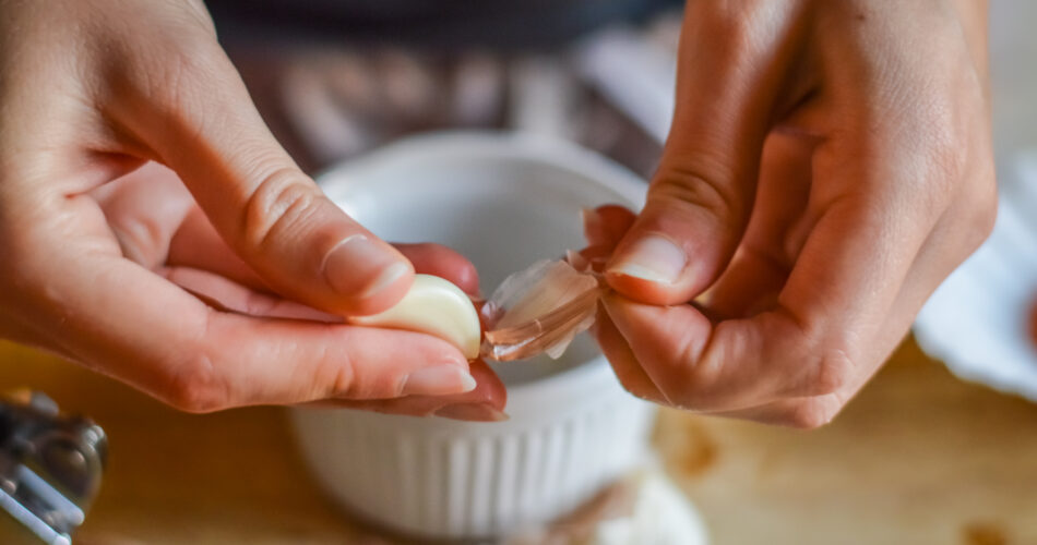 Peeling Garlic to make a cooking sauce - close up