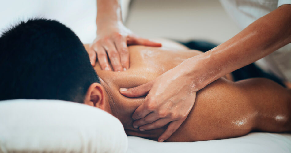 Sports massage. Physical therapist massaging shoulder region