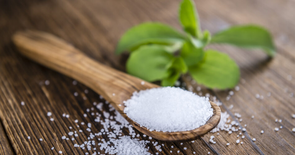 Old wooden table with Stevia Granules (selective focus; close-up shot)